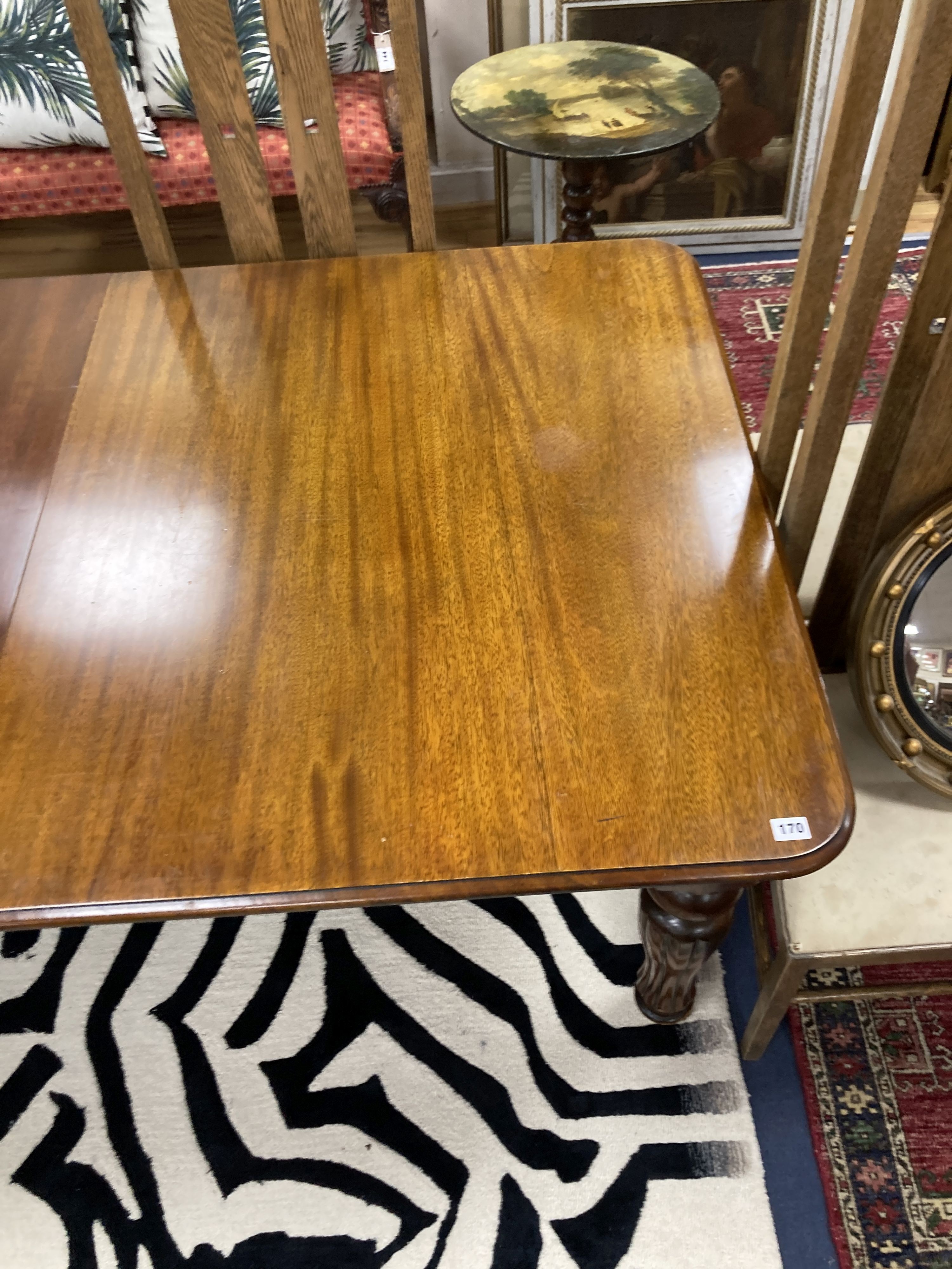 A Victorian style mahogany extending dining table. 214 extended, one spare leaf. W-100, H-74cm.